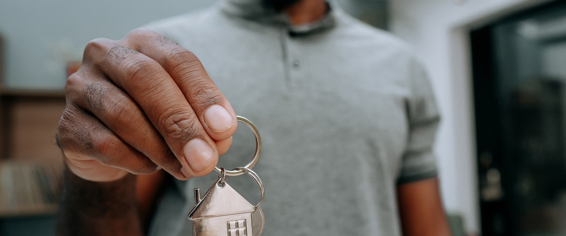 Man holding keys to his new home