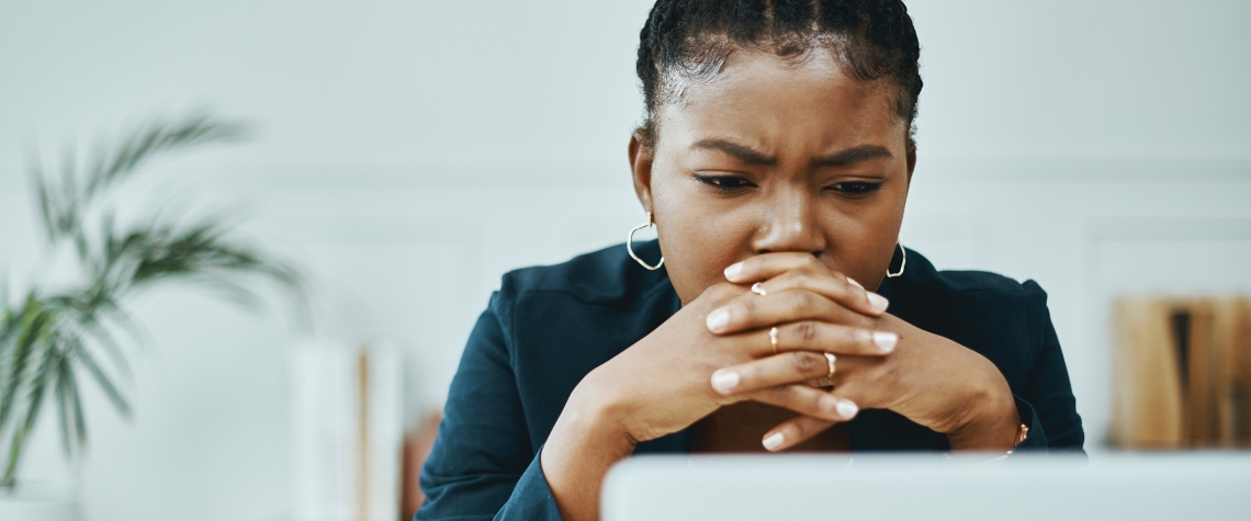 Lady looking at her laptop worried